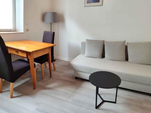 a living room with a couch and a table at Gästehaus Herda in Briedel