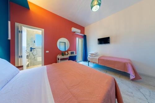 a bedroom with a large bed and a mirror at BeBaia in Leporano Marina