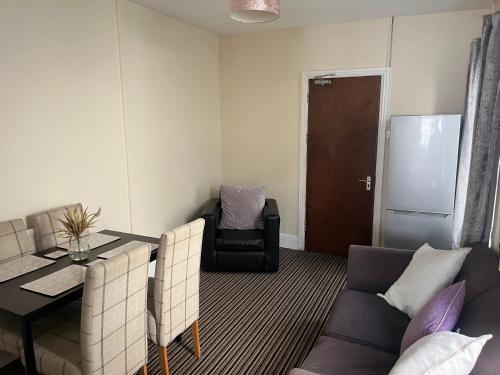 a living room with a table and a couch at 101 - Room 5 - Uplands in Sketty