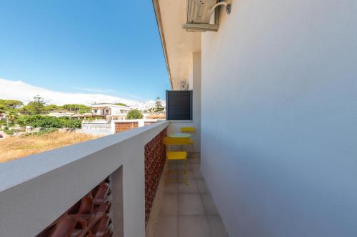 a room with a balcony with a view at BeBaia in Leporano Marina