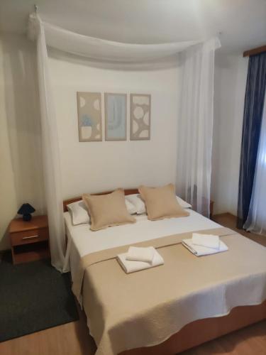 a bedroom with a large bed with two towels on it at VILLAGE apartment in Zagvozd