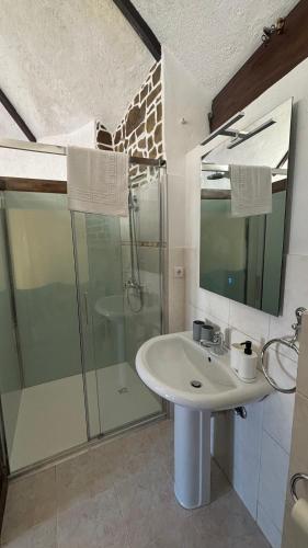 a bathroom with a sink and a shower at In Apúlia - Moinho do Mar in Apúlia