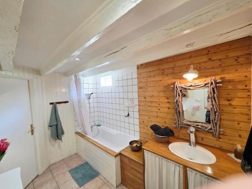 a bathroom with a tub and a sink and a bath tub at La Clef des Châteaux de la Loire, charme et zénitude in Azay-sur-Indre