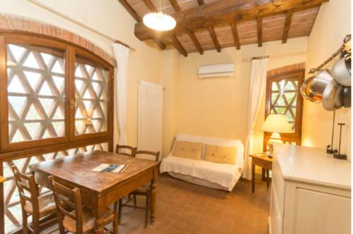 a living room with a bed and a table at Apartment With View In The Heart Of Chianti in Scopeti