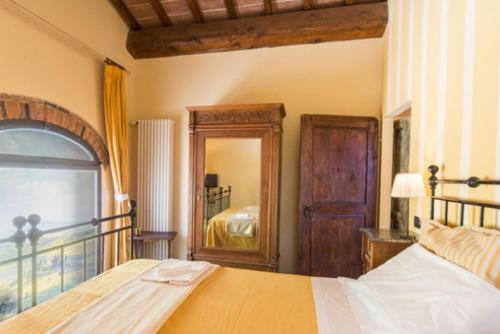 a bedroom with a bed and a large mirror at Apartment With View In The Heart Of Chianti in Scopeti