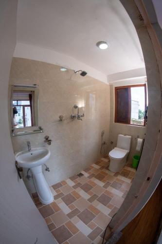 a bathroom with a sink and a toilet at Famous House Kathmandu in Kathmandu