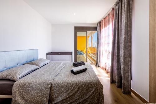 a bedroom with a bed and a large window at Sunset Palm Mar - Family Friendly Suites in Palm-Mar