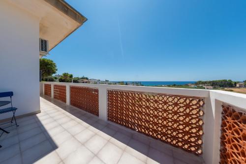 a balcony with a view of the ocean at BeBaia in Leporano Marina