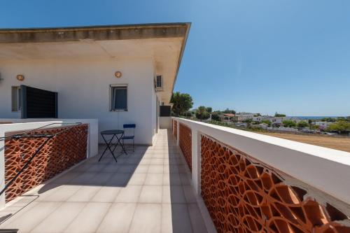 a balcony with a view of the ocean at BeBaia in Leporano Marina