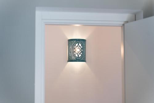 a light fixture on a wall in a room at BeBaia in Leporano Marina