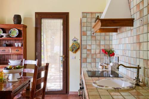 a kitchen with a sink and a counter top at Country House With Pool Among Noto Citrus Groves in Noto