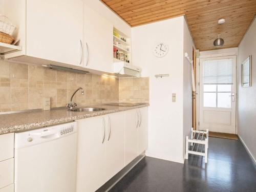 a kitchen with white cabinets and a sink at 5 person holiday home in Vestervig in Vestervig