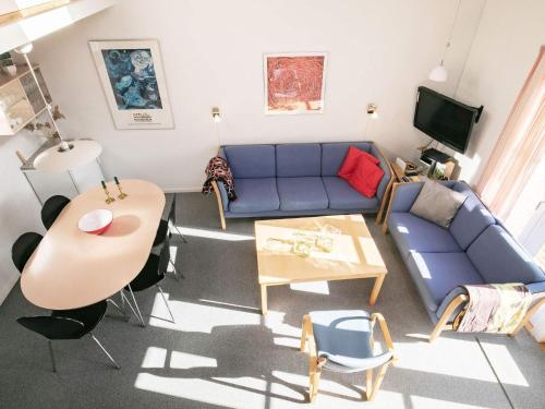 a living room with a blue couch and a table at 5 person holiday home in Vestervig in Vestervig
