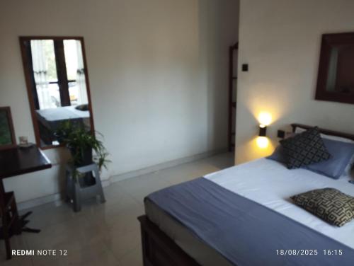 a bedroom with a bed and a desk and a window at Grand Jumbo residence in Bandarawela