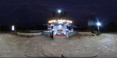 a building with a sign that reads motel what spin at night at Hotel Virat Stay in Hyderabad