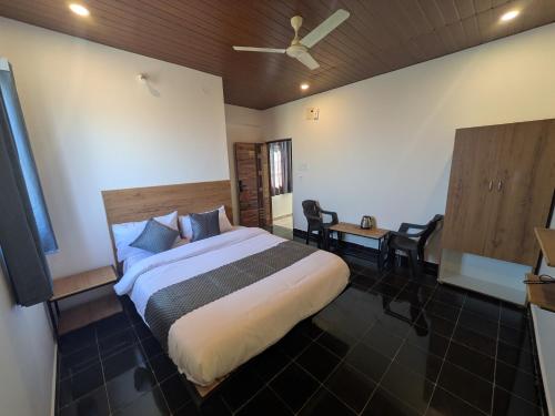 a bedroom with a bed and a table and chairs at Hotel Virat Stay in Hyderabad