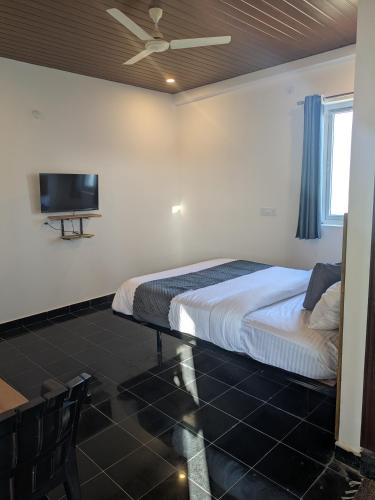 a bedroom with a bed and a flat screen tv at Hotel Virat Stay in Hyderabad