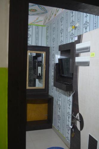 Una televisión o centro de entretenimiento en Hotel Goura