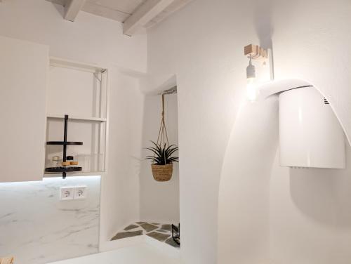 a white kitchen with a sink and a faucet at Agreli in Kinion