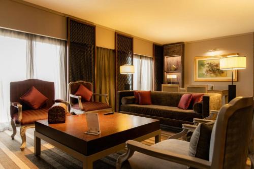 a living room with a couch and a table at Sheraton Lima Historic Center in Lima