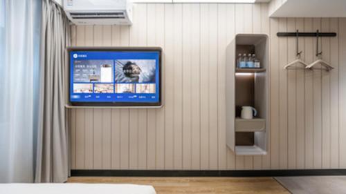a television on a wall in a room at Hanting Hotel Beijing Wanfeng Road Qilizhuang Subway Station in Beijing