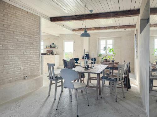 BallenNature Retreat With Sea View Near Ballen On Samsø的有桌子和椅子的餐厅