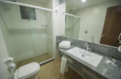 a bathroom with a toilet, sink, and bathtub at Casa Nova Hotel in Rio de Janeiro