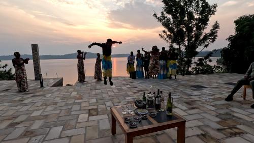 a group of people standing near a body of water at Umutuzo Lodge Kivu Lake in Buhoro