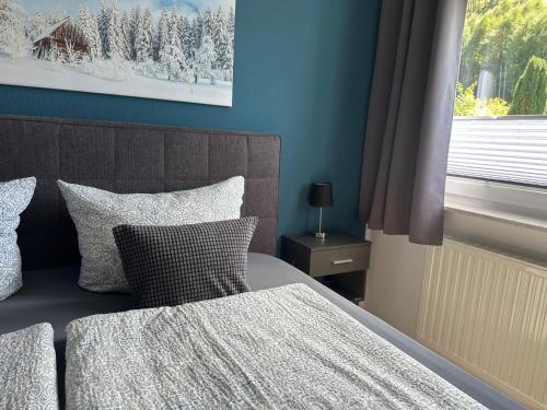 a bedroom with a bed with two pillows and a window at Ferienwohnung "Apartment Sunlife Winterberg" 4 Sterne in Winterberg