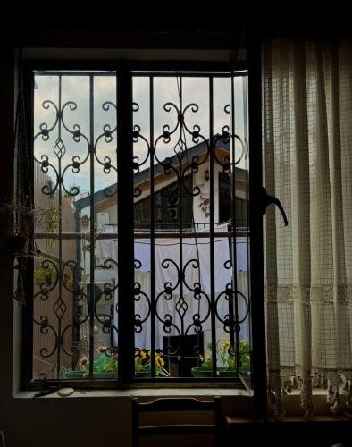 a window with a view of a building at Nitsa Guest House in Gori