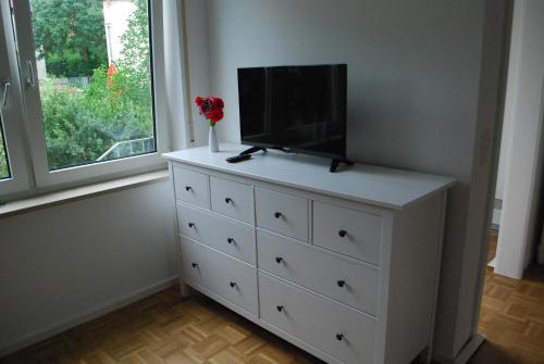 a white dresser with a tv on top of it at 1A Ferienwohnung Bamberg in Bamberg