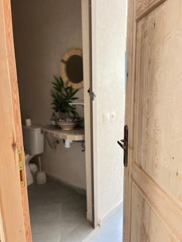 an open door to a bathroom with a toilet at Casa Z Morocco in Tamraght Ouzdar