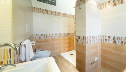 a bathroom with a toilet and a sink at Le rose di Mimmo Casa vacanze in Barcellona-Pozzo di Gotto