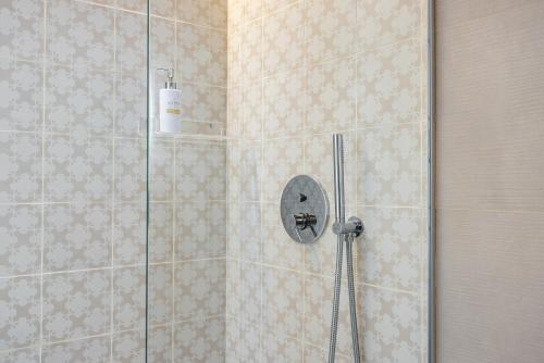 a shower with a glass door in a bathroom at Anita Rooms in Olbia