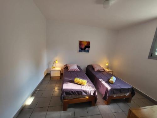 two twin beds in a room with two lamps at Vila Pejic Xenia beach in Paliouri