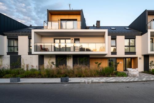 a large house with a black roof at Rąbieńska Urban Elegance Apartment by BookingHost in Łódź
