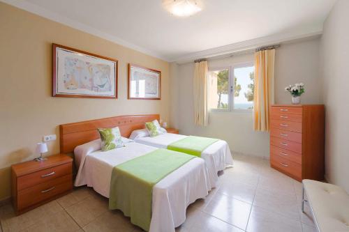 a bedroom with two beds and a window at 3378 Villa Portichol in Moraira