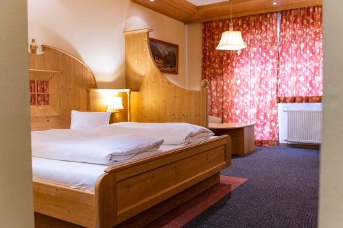 a bedroom with a large bed in a room at Alpin Panoramahotel Lärchenhof in Heiligenblut