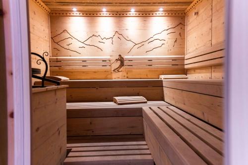 a sauna with wooden walls and wooden flooring at Alpin Panoramahotel Lärchenhof in Heiligenblut