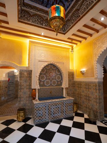 a room with a mosque with a checkered floor at Riad Qasr El Medina in Tangier
