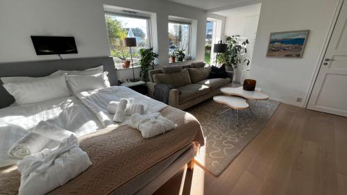 a bedroom with a bed and a living room at Casa Hönö Hästen in Hönö
