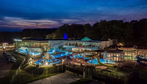 a large building with a swimming pool at night at Lawendowa Willa in Kaczki Średnie