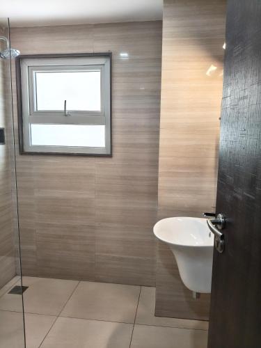 a bathroom with a sink and a window at Holiday Residency Coimbatore in Coimbatore