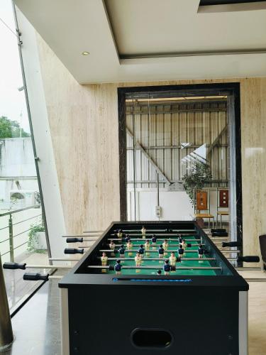 a pool table in the middle of a room at Holiday Residency Coimbatore in Coimbatore