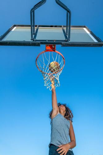 a woman dunking a basketball in a hoop at Szalajka Liget Hotel és Apartmanházak in Szilvásvárad