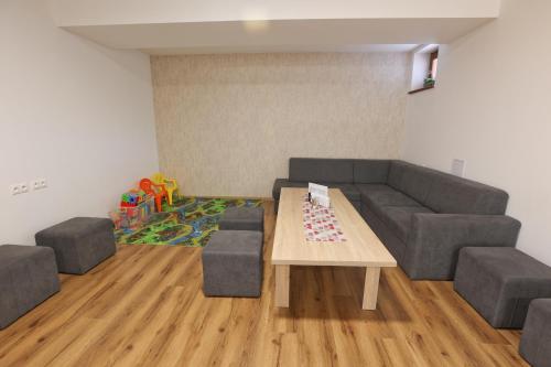 a living room with a couch and a table at Penzión Zlatny Potok in Mutné