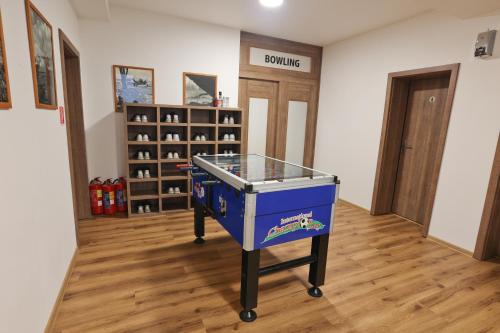 a ping pong table in the middle of a room at Penzión Zlatny Potok in Mutné