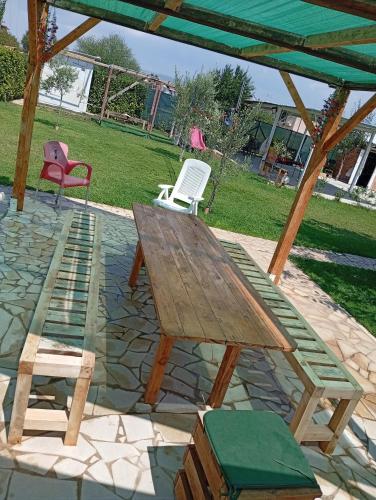 a wooden picnic table and chairs on a patio at Filuvespri in Comiso