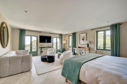 a bedroom with a large bed and a living room at Luxury Villa With Sea View In Le Lavandou in Le Lavandou