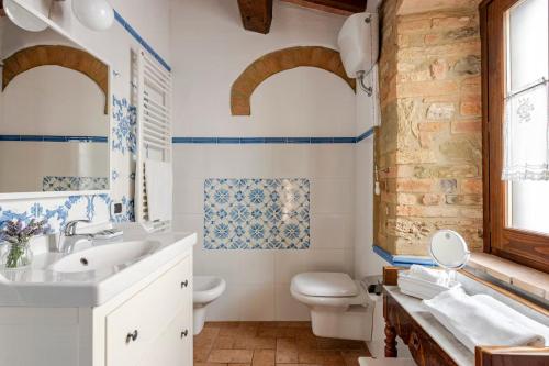 a bathroom with a sink and a toilet at Historic Village With Pool Near Todi in Todi